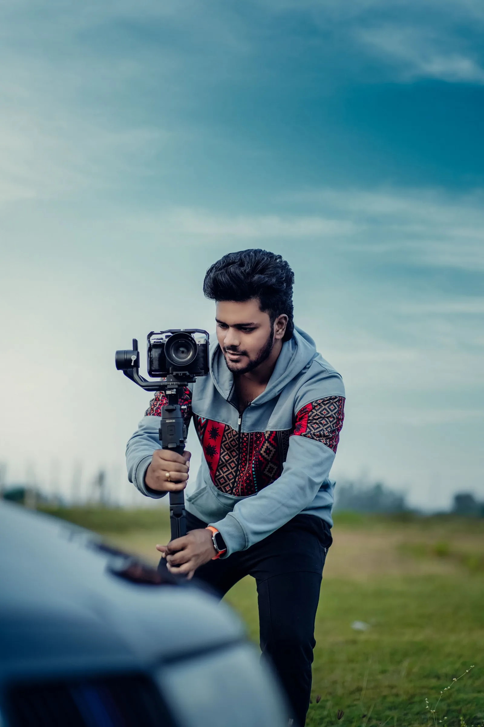 Videographer filming outdoors with a camera on a gimbal